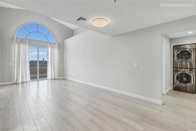a view of a room with wooden floor and ceiling fan