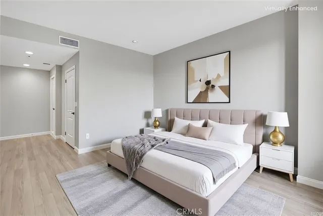 a bedroom with a bed and a painting on the wall