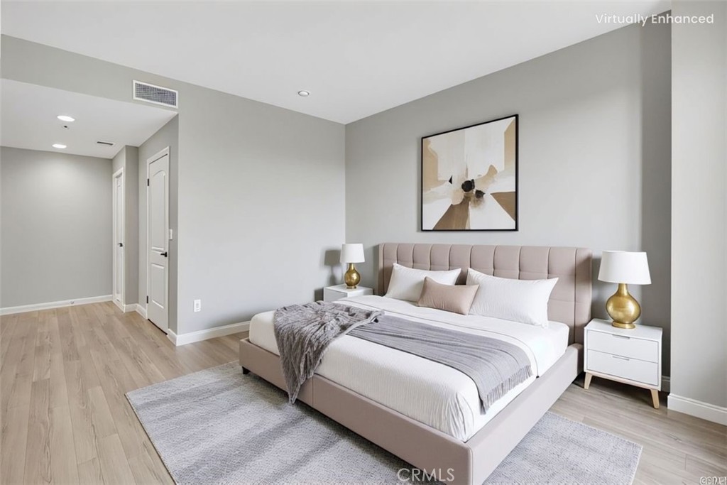 6800 Corbin Avenue, Unit 308 Reseda, CA 91335 - Photo 5 of 11 a bedroom with a bed and a painting on the wall