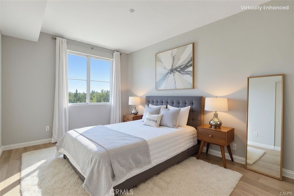 6800 Corbin Avenue, Unit 308 Reseda, CA 91335 - Photo 7 of 11 a bedroom with a bed and wooden floor