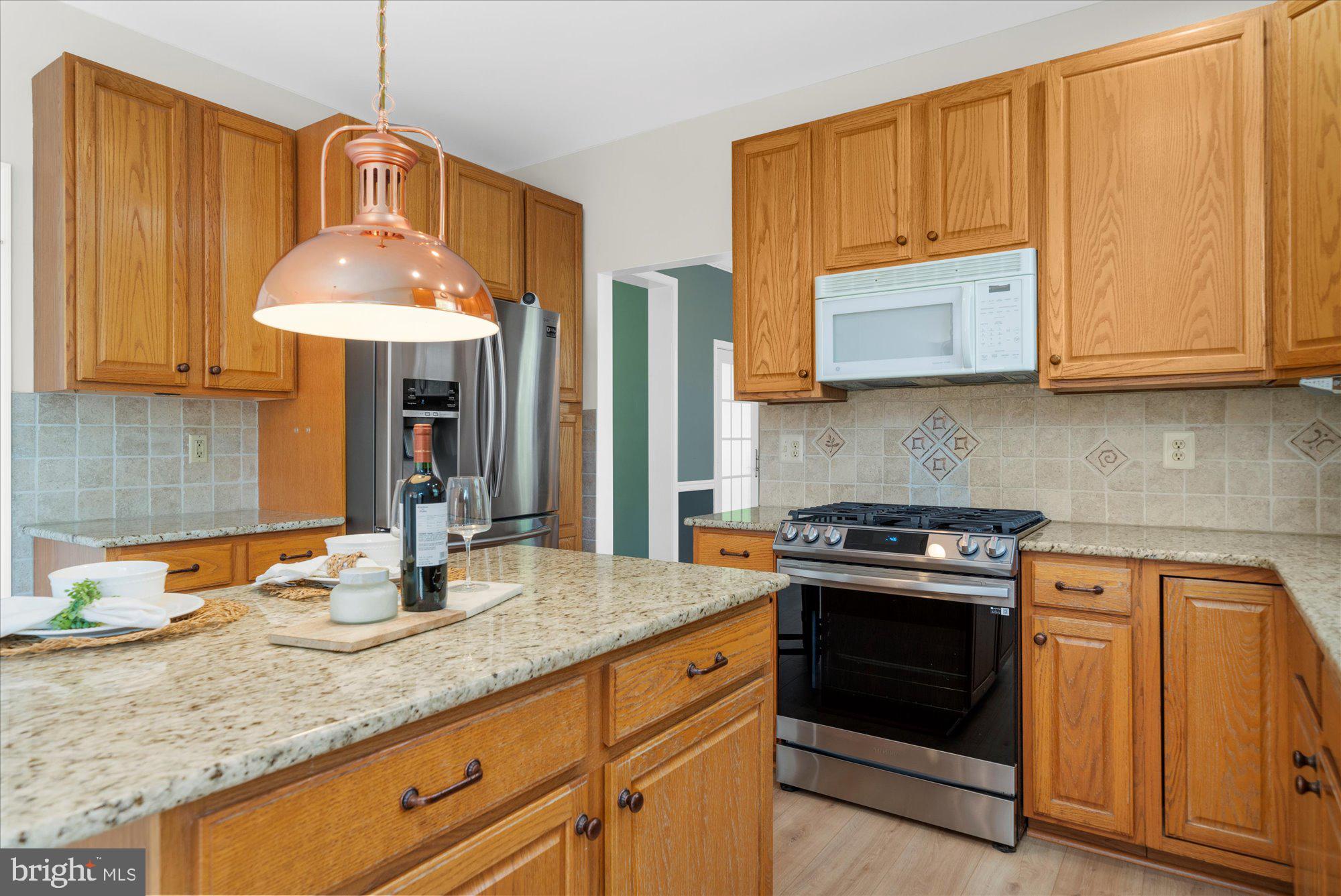 131 Appledale Road Norristown, PA 19403 - Photo 13 of 50 a kitchen with granite countertop wooden cabinets and a stove
