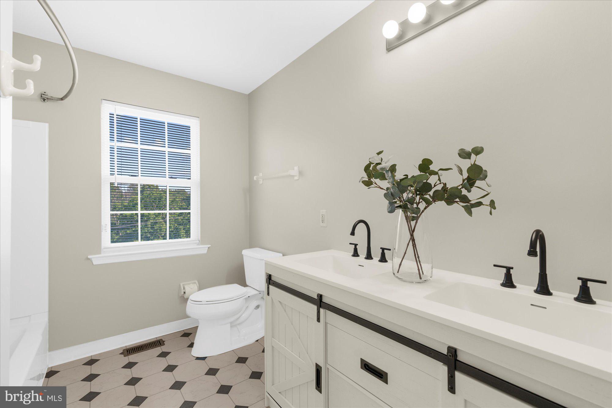 131 Appledale Road Norristown, PA 19403 - Photo 29 of 50 a bathroom with a sink a toilet and a window