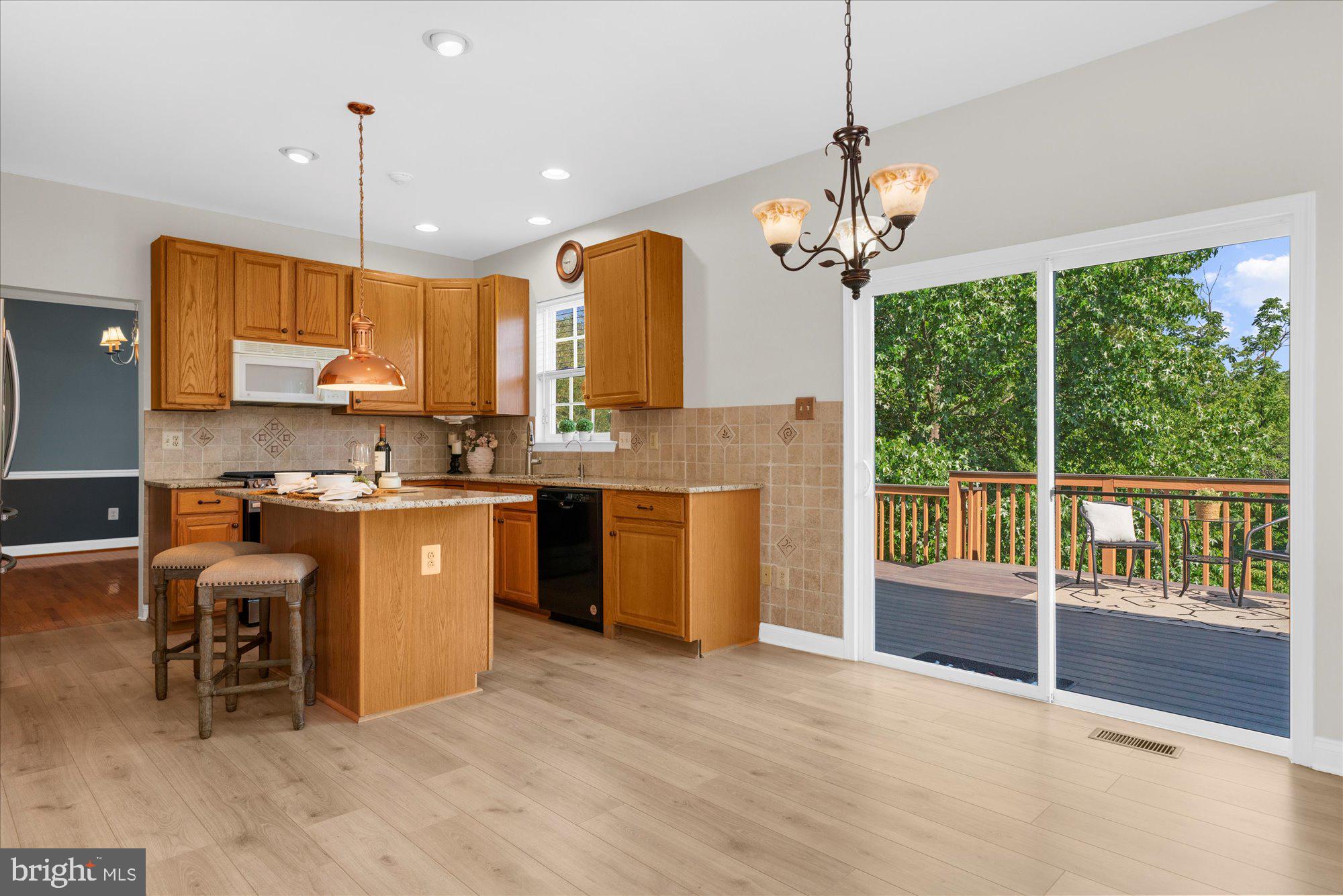 131 Appledale Road Norristown, PA 19403 - Photo 10 of 50 a open kitchen with stainless steel appliances granite countertop a stove a sink a center island a dining table and chairs