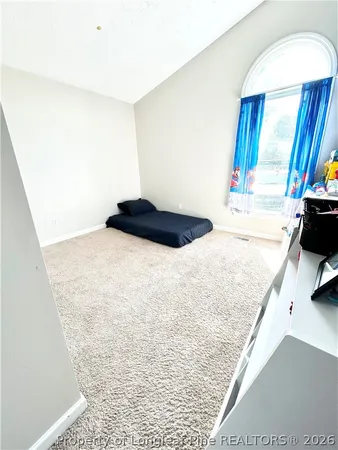 a bathroom with a shower curtain and a window