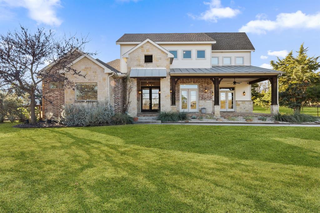 a front view of a house with a garden and outdoor seating