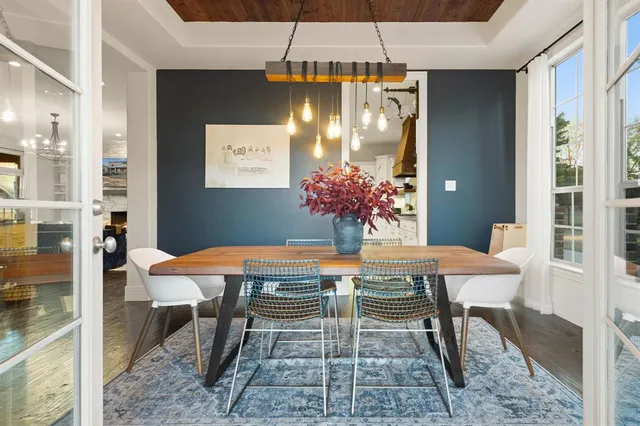 a dining room with furniture and chandelier