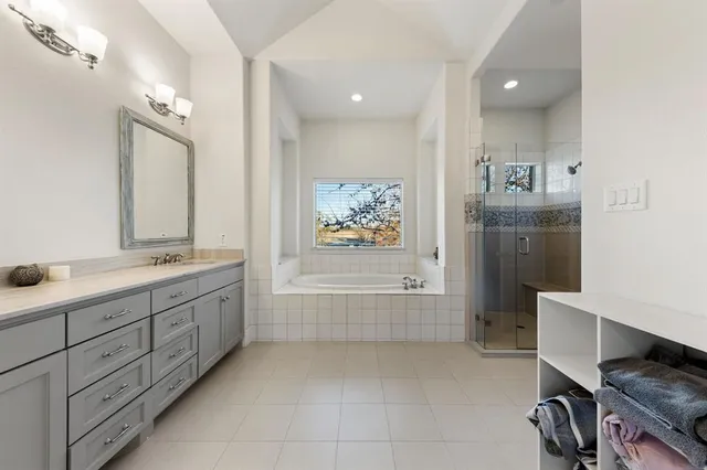 a bathroom with a tub sink and mirror