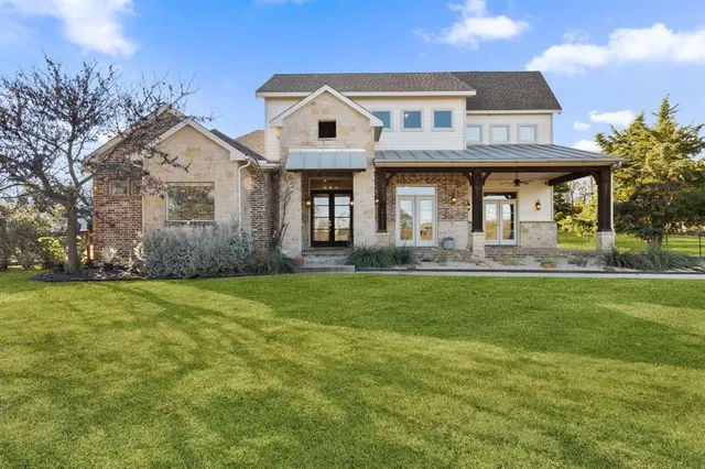 a front view of a house with a garden and outdoor seating