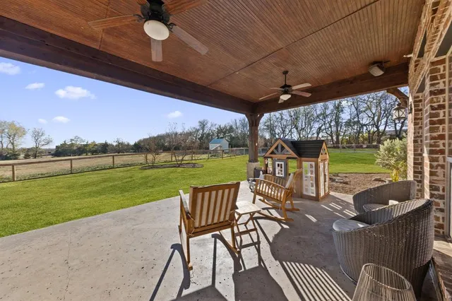 a view of a patio with a table chairs and a backyard