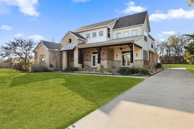 a front view of a house with garden