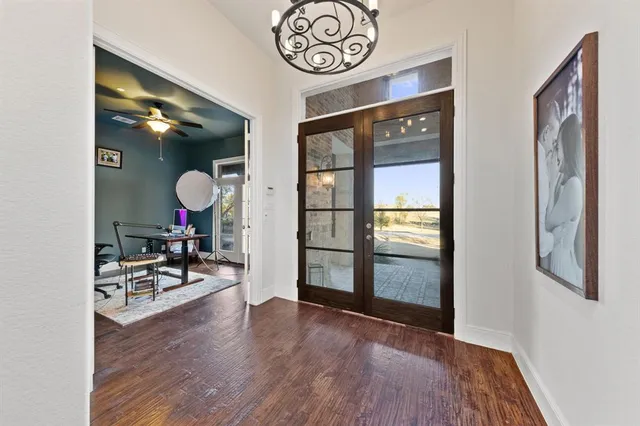 a view of a hallway to dining room and livingroom with furniture