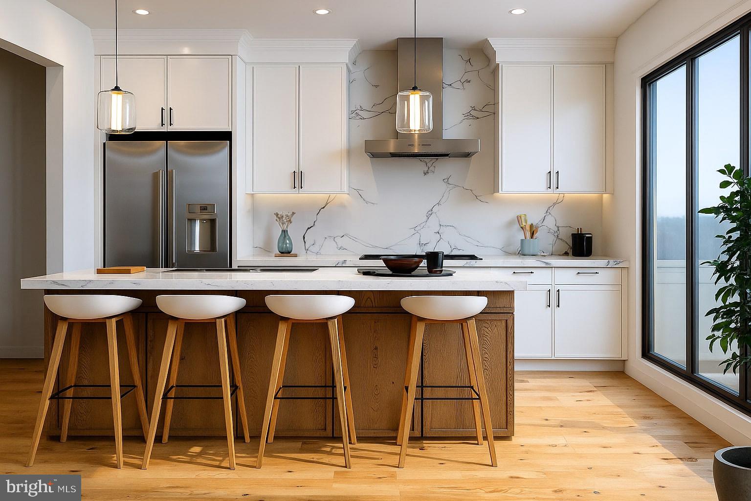 331 Reed Street Philadelphia, PA 19147 - Photo 2 of 2 a kitchen with stainless steel appliances kitchen island a table chairs in it and wooden floors