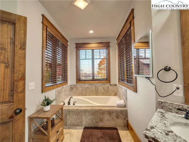 a bath tub sitting in a bathroom next to a window