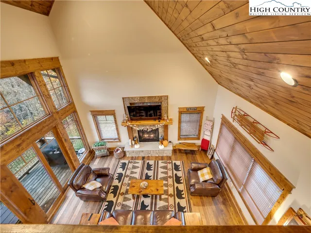 a view of a living room with furniture and a fireplace