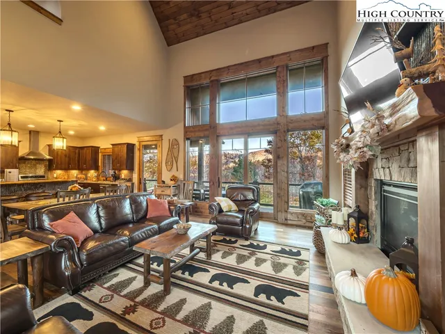 a living room with lots of furniture and a fireplace