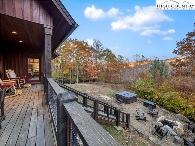 a balcony with wooden floor and outdoor seating
