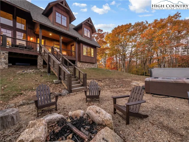 a backyard of a house with barbeque oven table and chairs