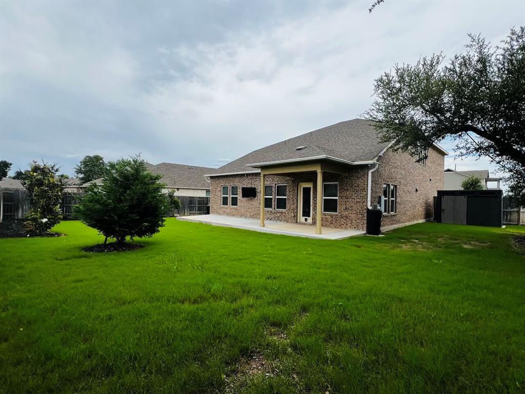 1509 Deering Run Leander, TX 78641 - Photo 38 of 40 Expansive green lawn with mature trees and a covered patio