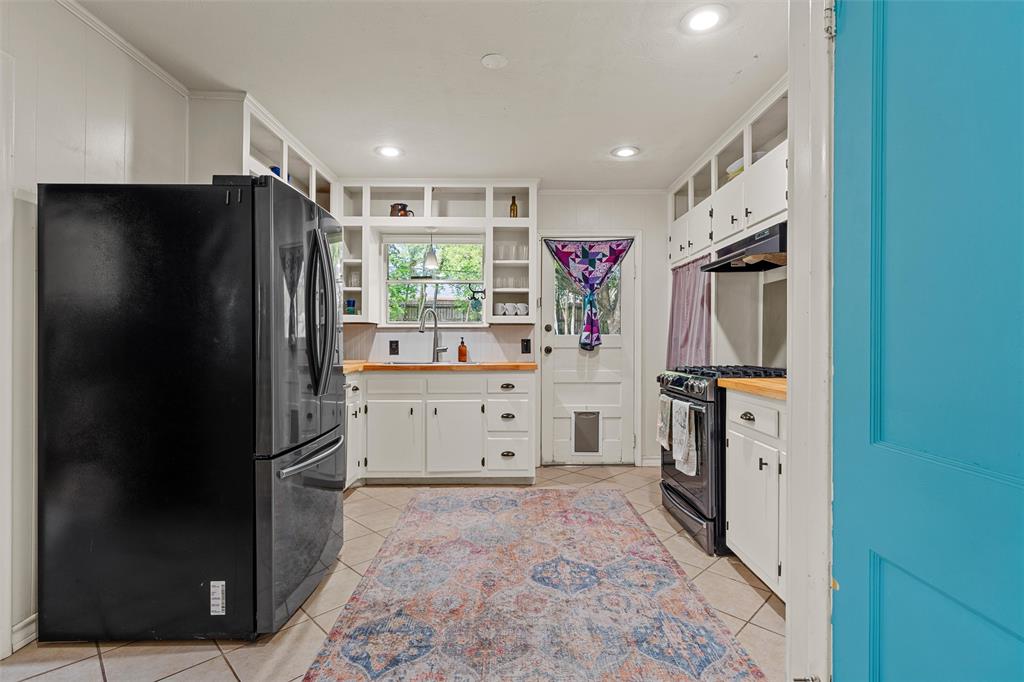 2216 Hermanson Drive Waco, TX 76710 - Photo 10 of 39 a kitchen with white cabinets and refrigerator