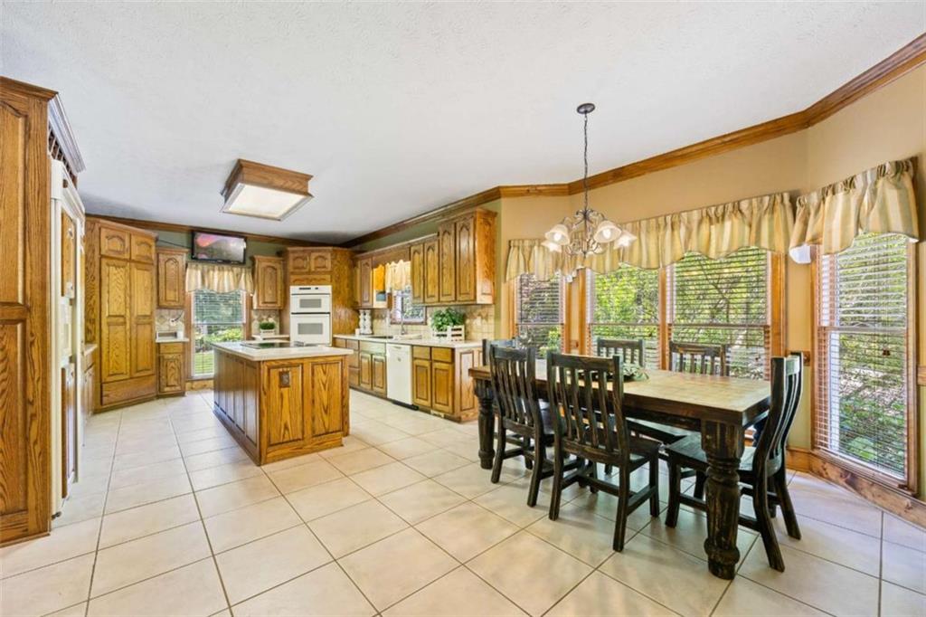 3651 Chandler Haulk Road Loganville, GA 30052 - Photo 17 of 33 a dining hall with stainless steel appliances a dining table and chairs