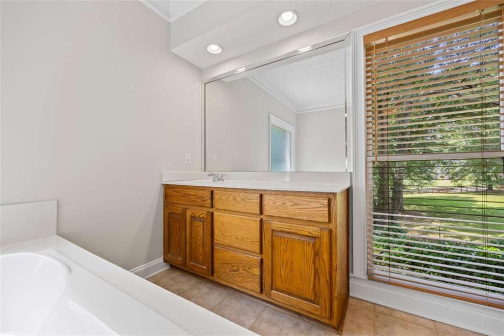 3651 Chandler Haulk Road Loganville, GA 30052 - Photo 22 of 33 a bathroom with a sink a mirror and shower