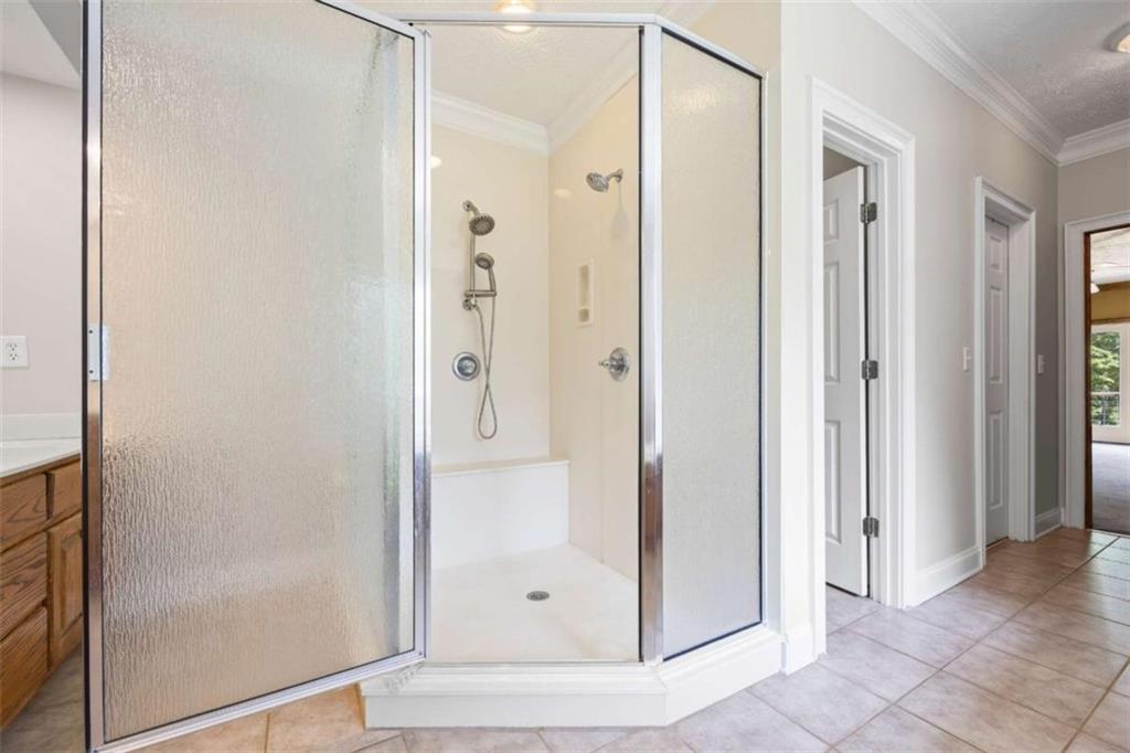 3651 Chandler Haulk Road Loganville, GA 30052 - Photo 24 of 33 a bathroom with a glass shower door and a glass door