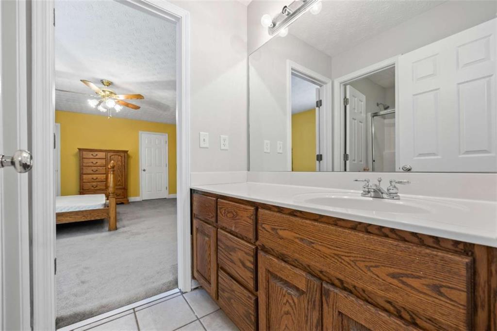 3651 Chandler Haulk Road Loganville, GA 30052 - Photo 28 of 33 a bathroom with a sink a vanity a mirror and a bathtub