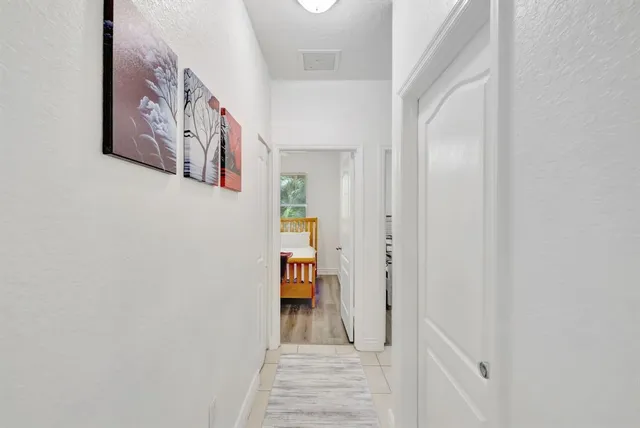 a view of a hallway with paintings on the wall