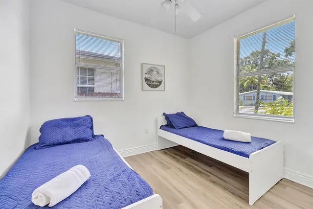 a view of a bedroom with furniture and wooden floor