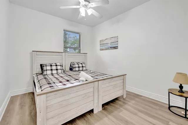 a bedroom with a bed and a chandelier