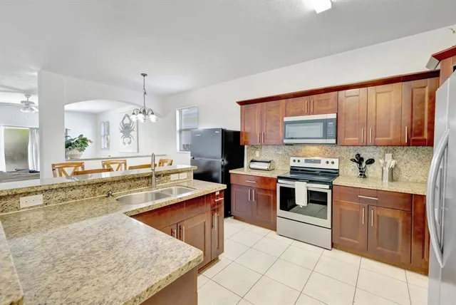 a large kitchen with cabinets appliances and a counter space