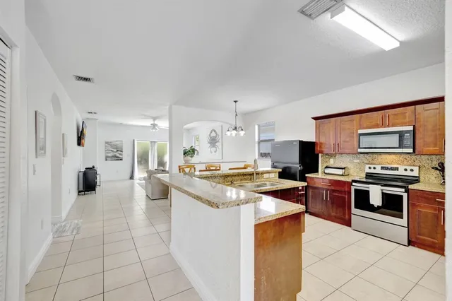 a large kitchen with cabinets and stainless steel appliances