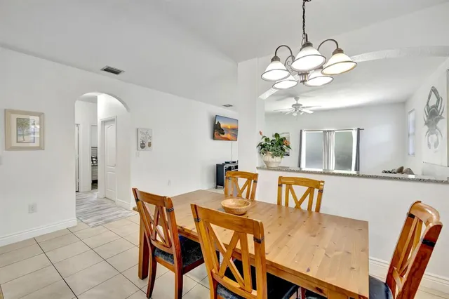 a view of a dining room with furniture and chandelier