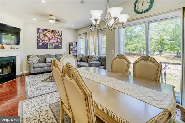 a living room with furniture chandelier and a large window