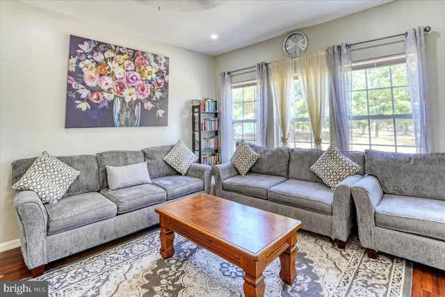 a living room with furniture a rug and a large window