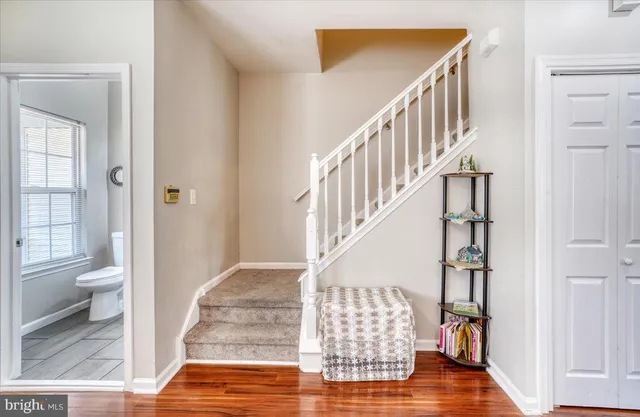 a view of entryway and hall with wooden floor