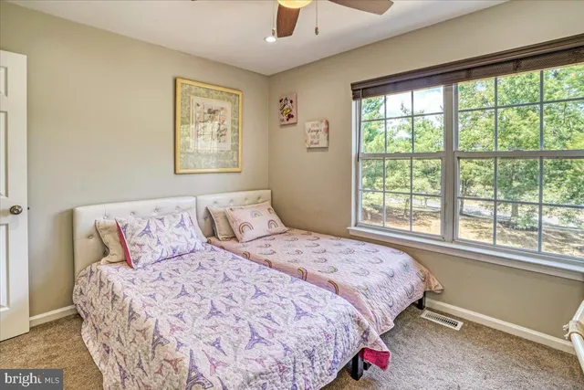 a bedroom with a large bed and a large window