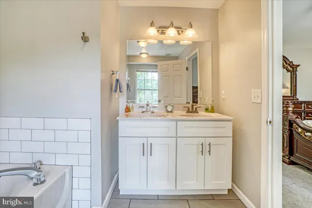 a bathroom with a sink vanity and a mirror