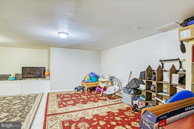 a room with lots of white furniture and wooden floor