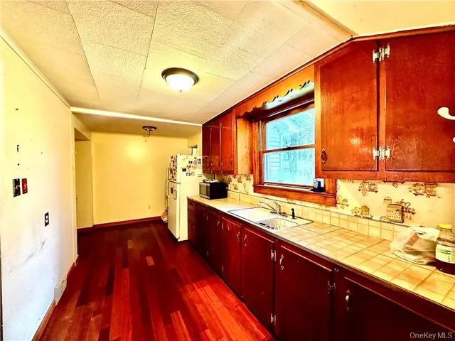 a kitchen with wooden floors and a sink