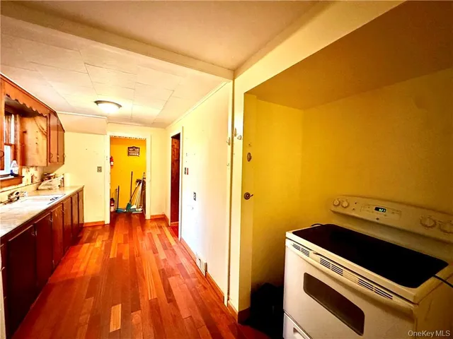 a kitchen with wooden floor and a sink