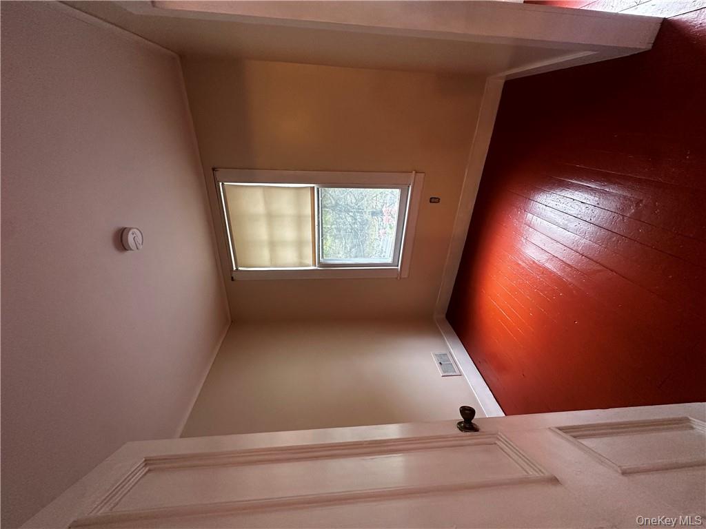 112 Eldred-Yulan Road Eldred, NY 12732 - Photo 25 of 26 an empty room with wooden floor and windows