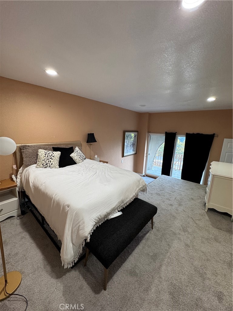 27914 West Shore Road Lake Arrowhead, CA 92352 - Photo 11 of 22 a bedroom with a bed and mirror