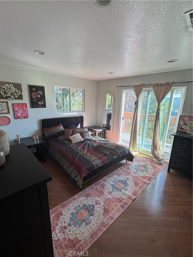 27914 West Shore Road Lake Arrowhead, CA 92352 - Photo 16 of 22 a bed sitting in a bedroom next to a window