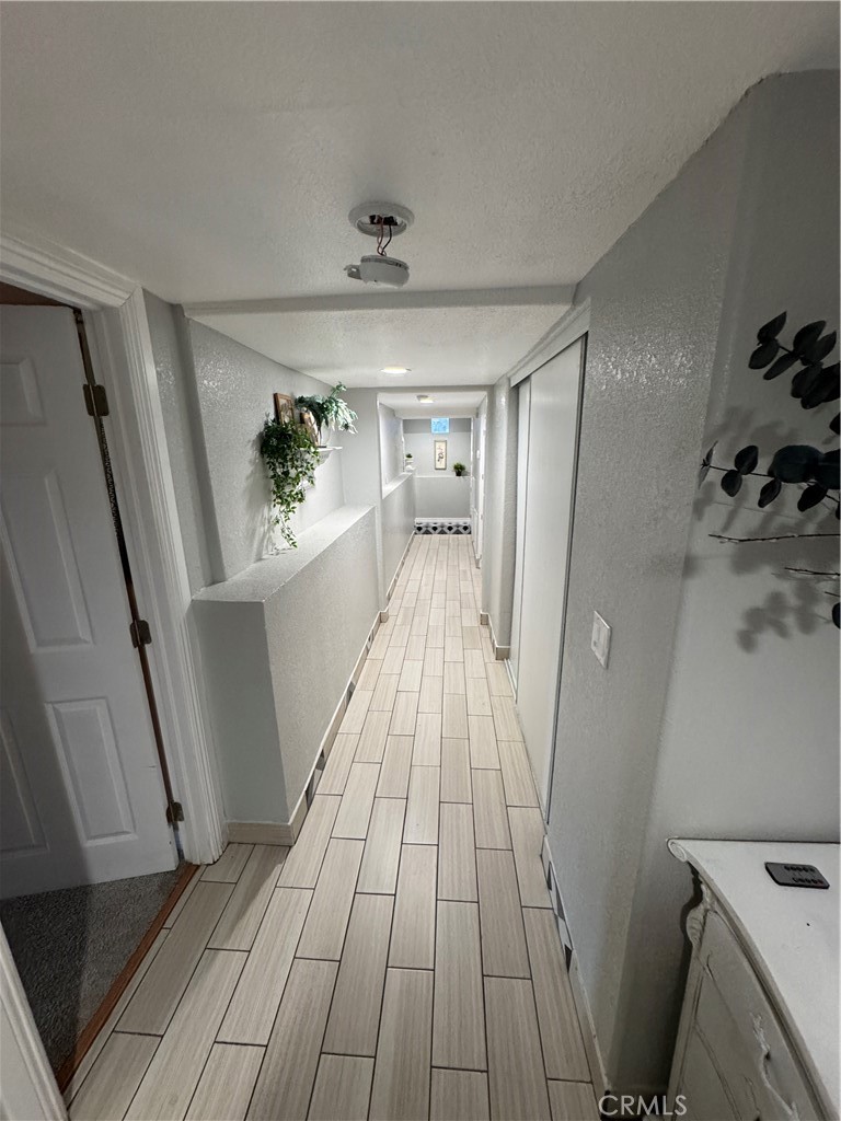 27914 West Shore Road Lake Arrowhead, CA 92352 - Photo 21 of 22 a view of a hallway view with wooden floor and staircase