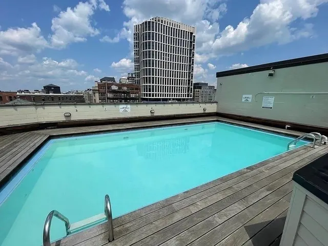 a view of a swimming pool with a lounge chair