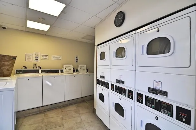 a utility room with multiple dryer and washer