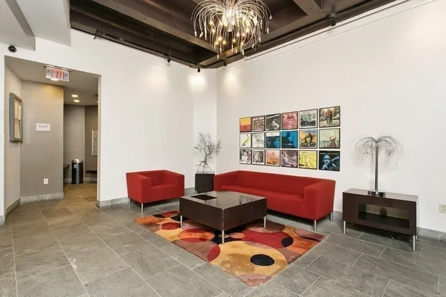 a living room with furniture a rug and a chandelier