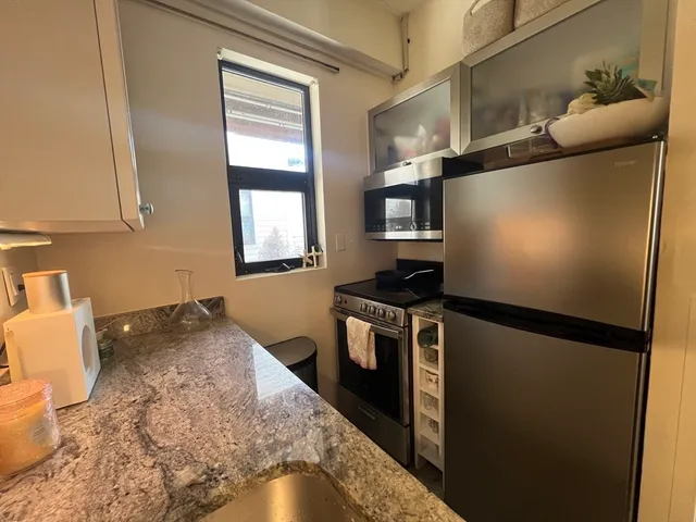 a kitchen with a refrigerator and a stove