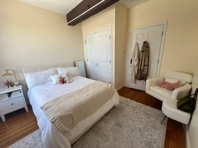 a bedroom with a bed and a mirror